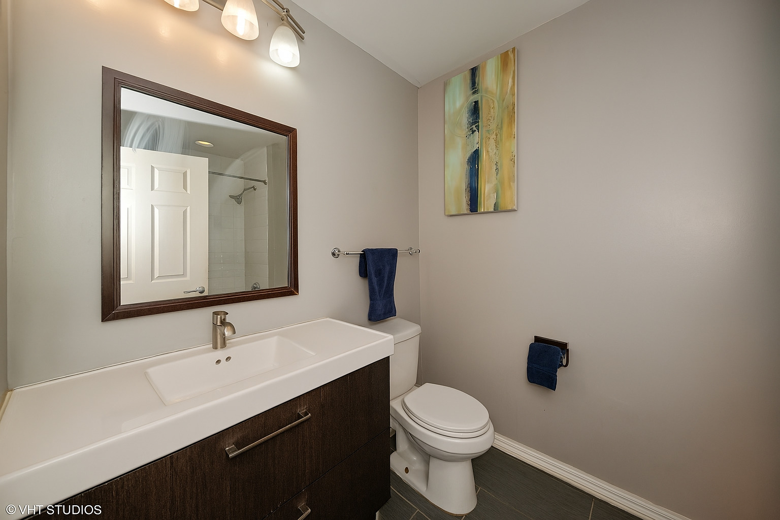 1255 South State Street, Unit 1802 Chicago, IL 60605 - Photo 7 of 11 a bathroom with a toilet sink a mirror and vanity