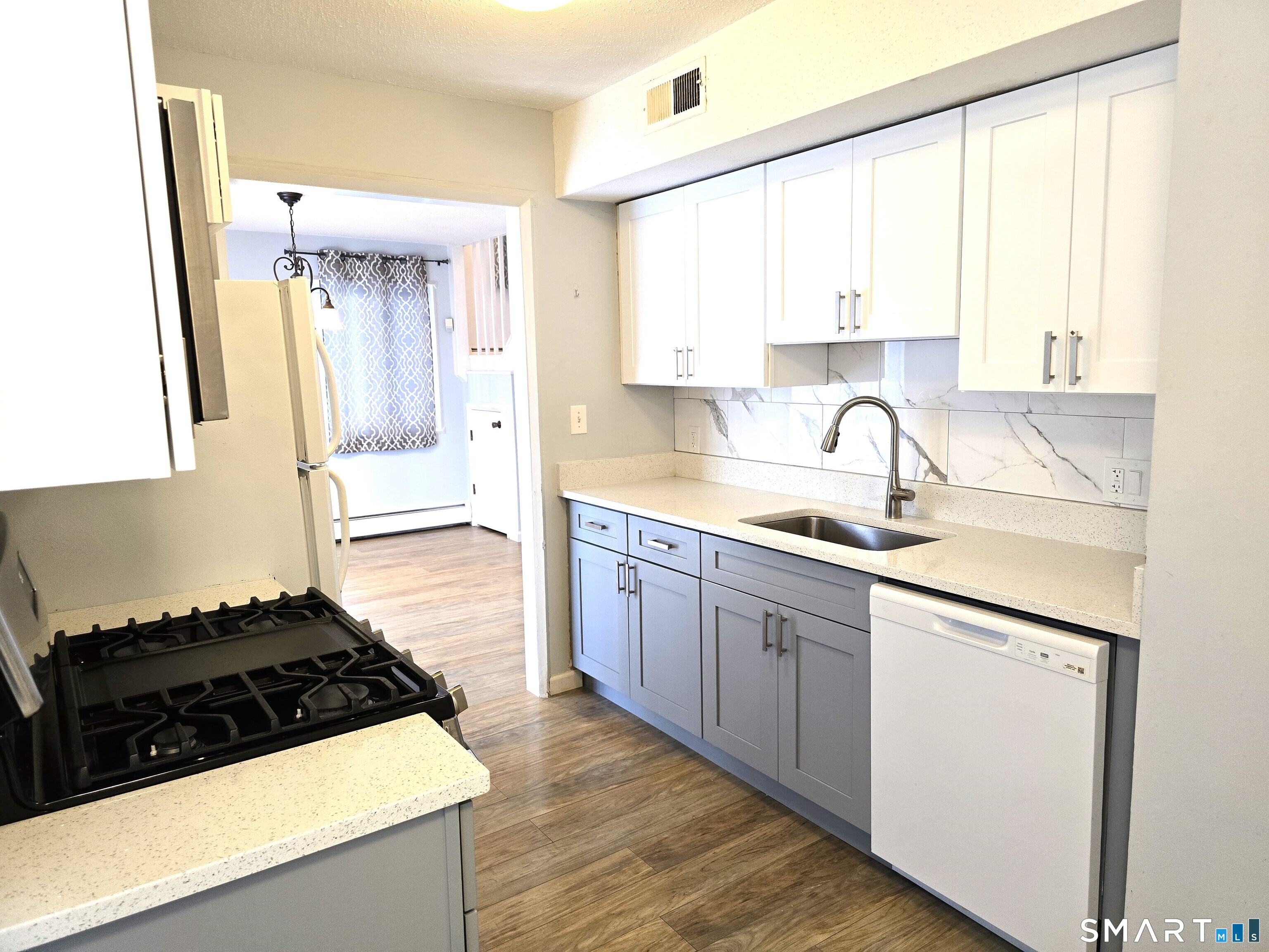 7 Staunton Court, Unit E Farmington, CT 06032 - Photo 12 of 29 a kitchen with a sink stove and cabinets