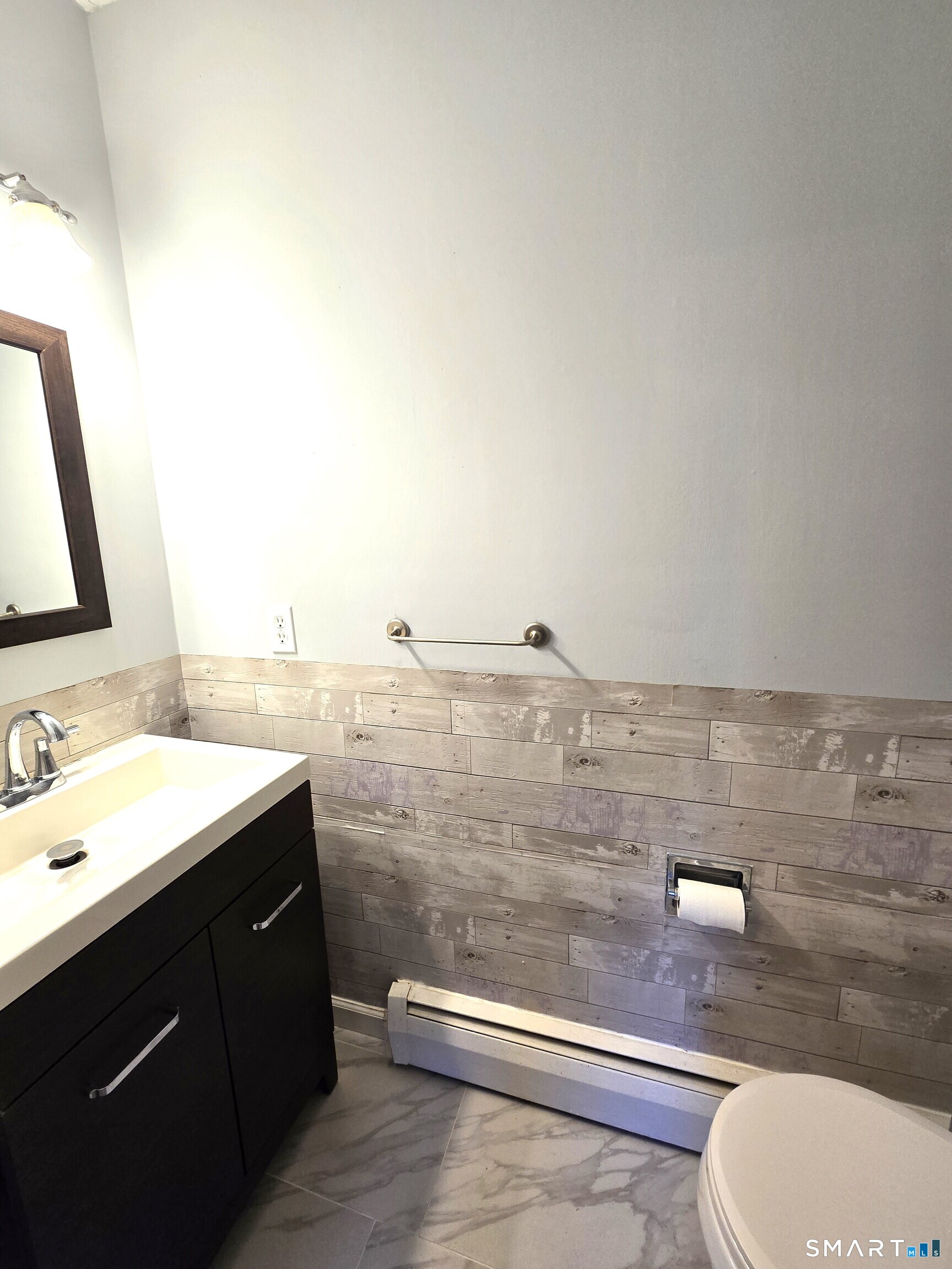 7 Staunton Court, Unit E Farmington, CT 06032 - Photo 13 of 29 a bathroom with a sink a toilet and mirror