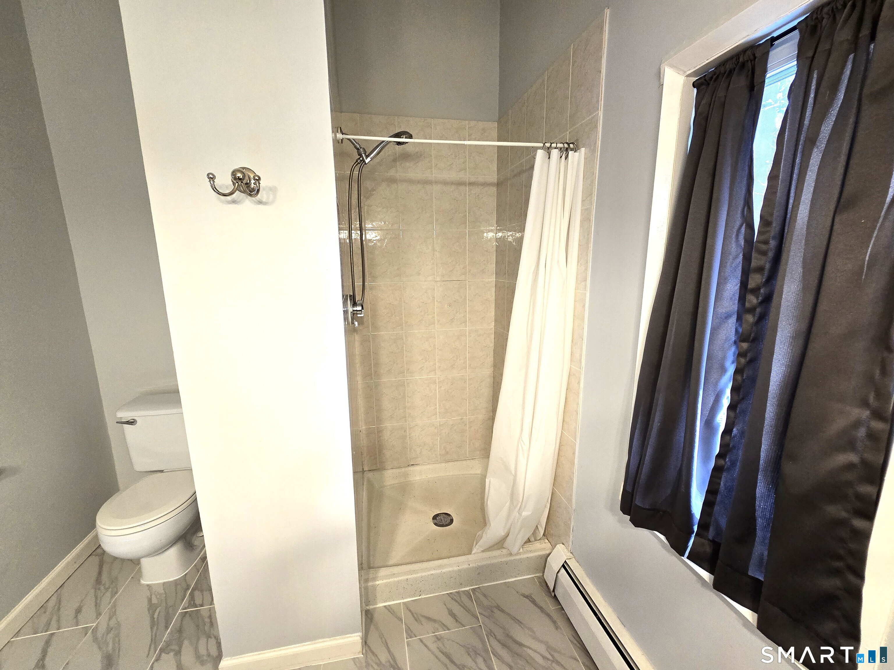 7 Staunton Court, Unit E Farmington, CT 06032 - Photo 18 of 29 a bathroom with a shower and a toilet