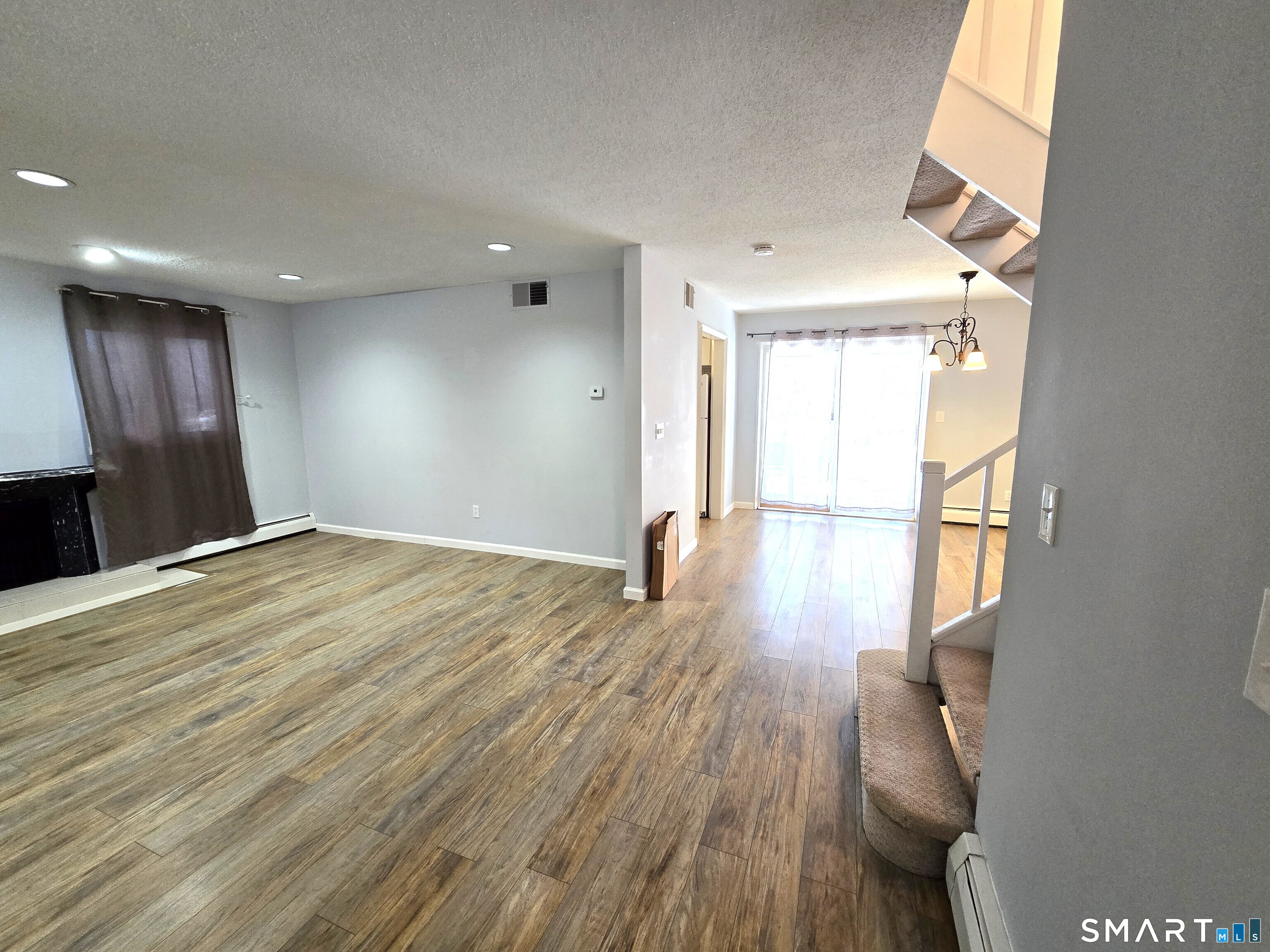7 Staunton Court, Unit E Farmington, CT 06032 - Photo 2 of 29 a view of empty room with wooden floor and fan