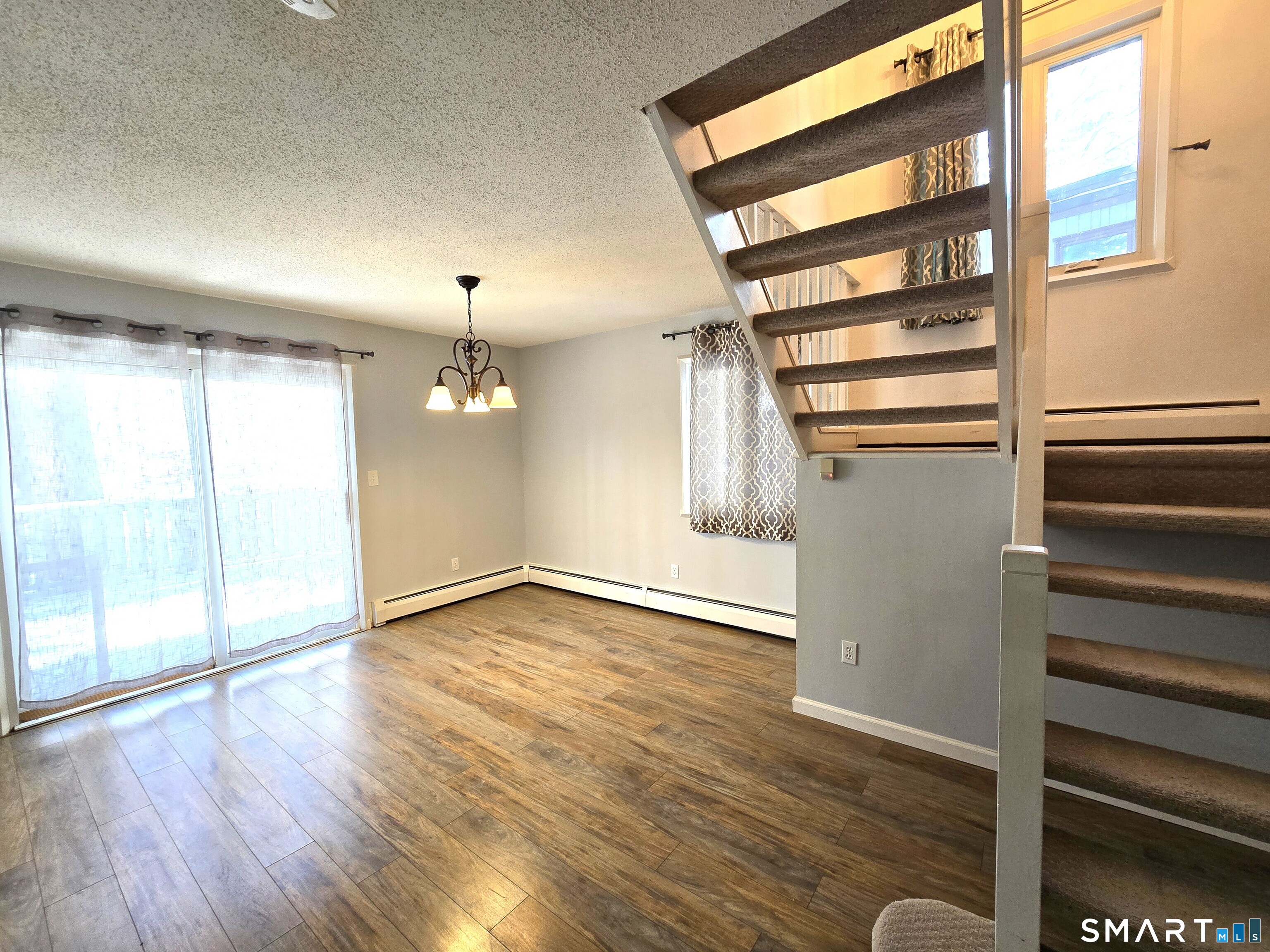 7 Staunton Court, Unit E Farmington, CT 06032 - Photo 6 of 29 wooden floor in an empty room with a window
