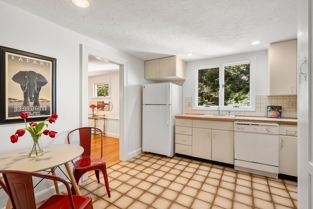 49 Pierrepont Road Newton, MA 02462 - Photo 5 of 16 a kitchen with a refrigerator and windows