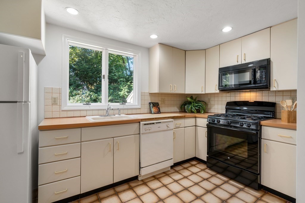 49 Pierrepont Road Newton, MA 02462 - Photo 6 of 16 a kitchen with a sink stove and microwave