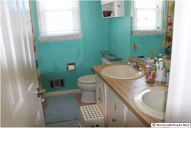 23 Pittsfield Road Howell, NJ 07731 - Photo 18 of 24 a bathroom with a sink toilet and mirror