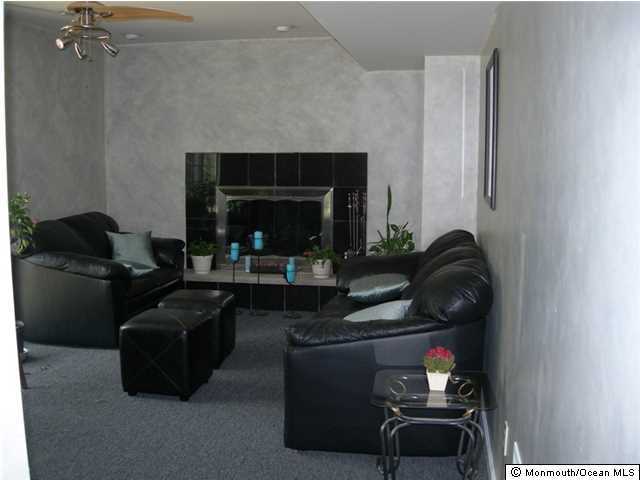 23 Pittsfield Road Howell, NJ 07731 - Photo 19 of 24 a living room with furniture and a fireplace