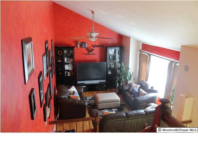 23 Pittsfield Road Howell, NJ 07731 - Photo 10 of 24 a living room with furniture a rug and a flat screen tv