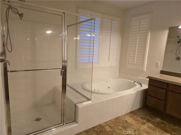 a bathroom with a bathtub and a shower