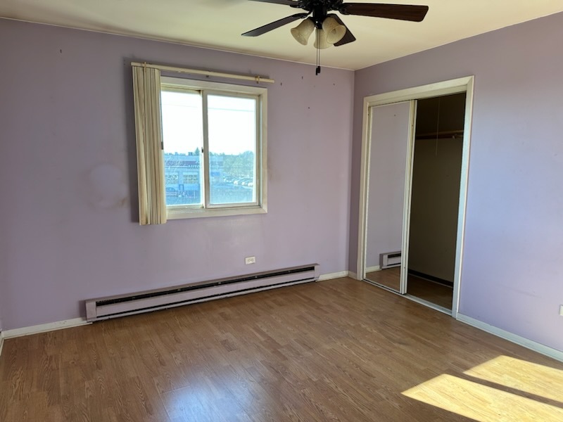 2356 Gaylord Road, Unit 3C Crest Hill, IL 60403 - Photo 8 of 9 an empty room with a window and a ceiling fan