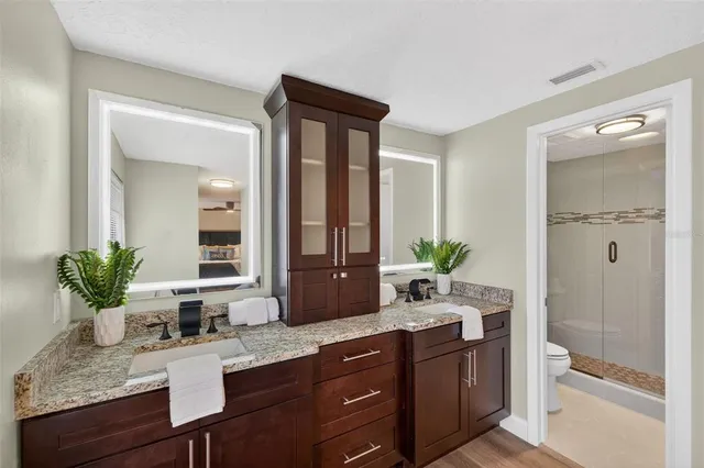 a front view of a house with a yard and potted plants