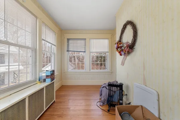 a hallway with windows and wooden floor