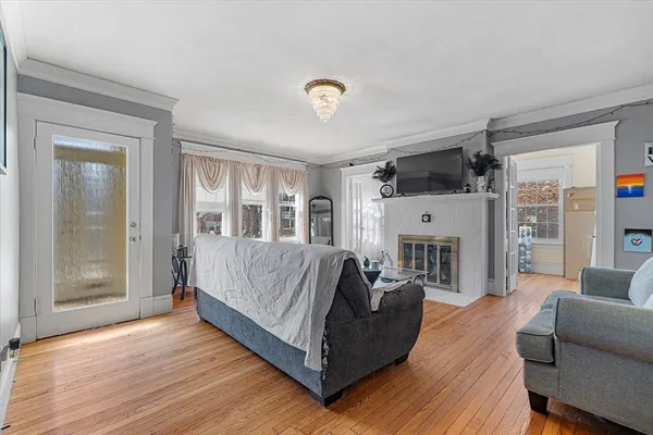 a living room with furniture fireplace and a window