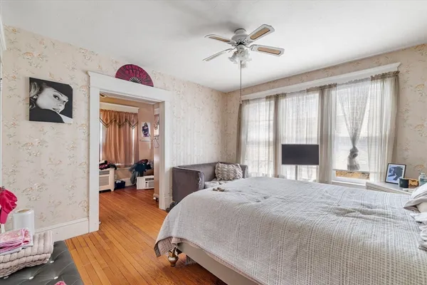 a spacious bedroom with a bed and a chandelier