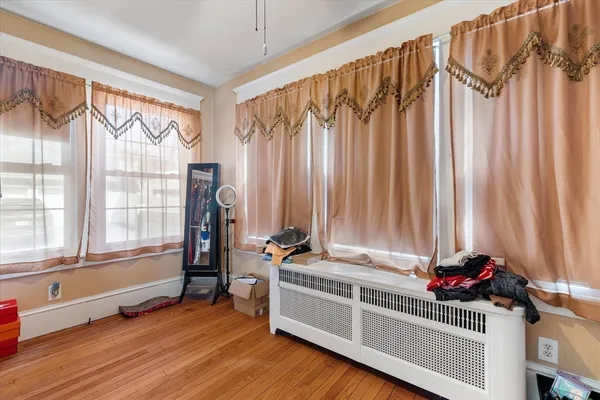 a living room with a bed and a window