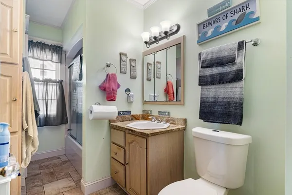a bathroom with a sink vanity mirror and toilet