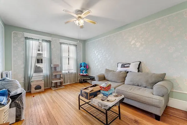 a living room with furniture and wooden floor