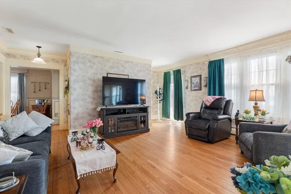 a living room with fireplace furniture and a flat screen tv