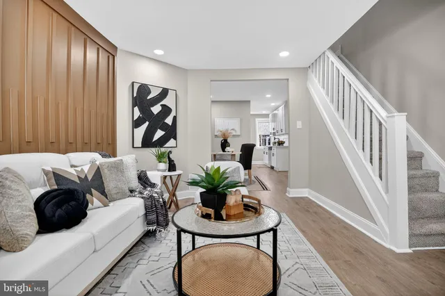 a living room with furniture a table and a potted plant