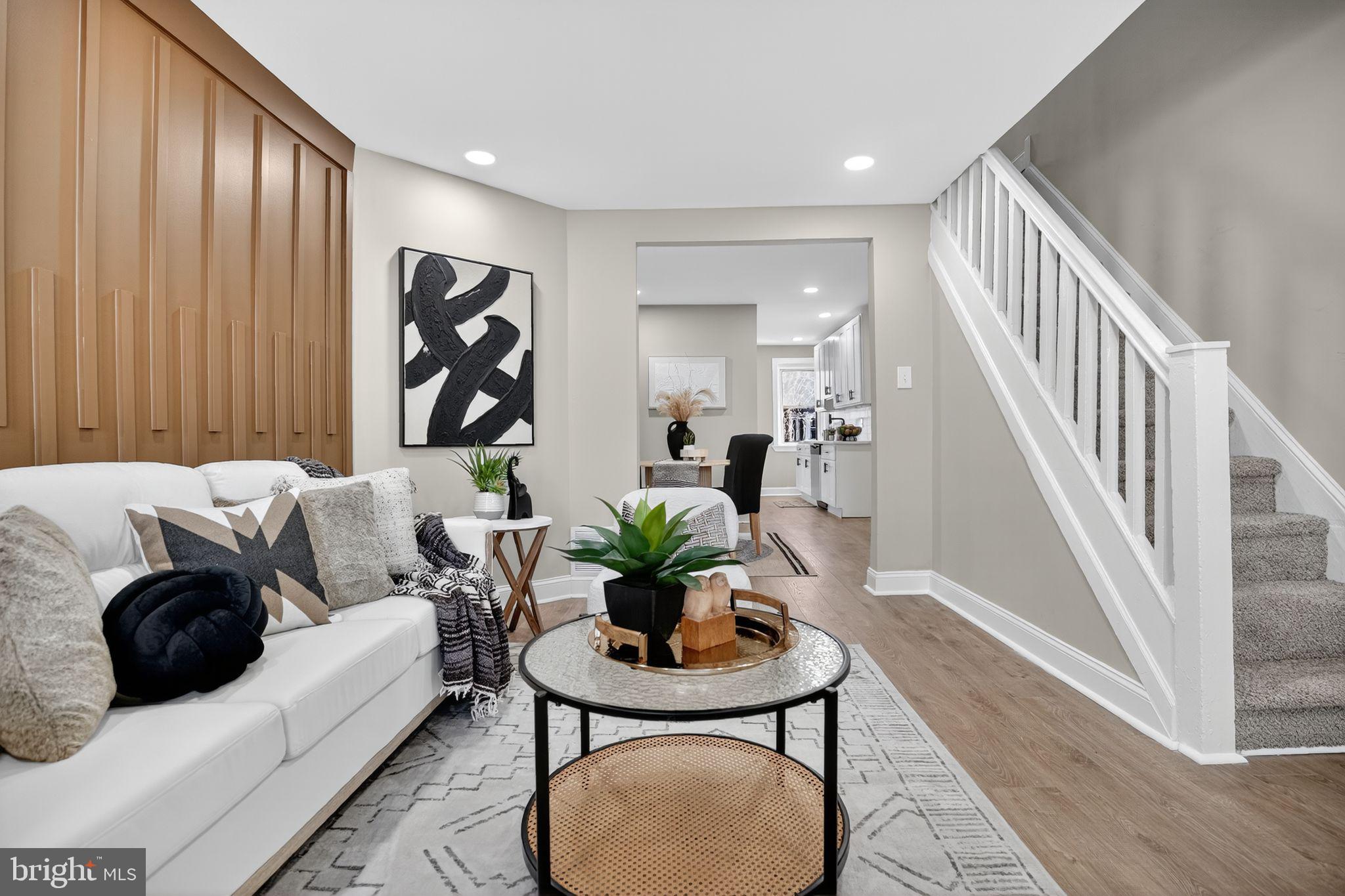 a living room with furniture a table and a potted plant