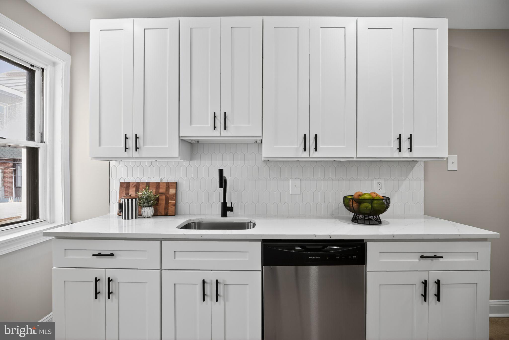 258 West Sheldon Street Philadelphia, PA 19120 - Photo 12 of 29 a kitchen with white cabinets and a wooden floor
