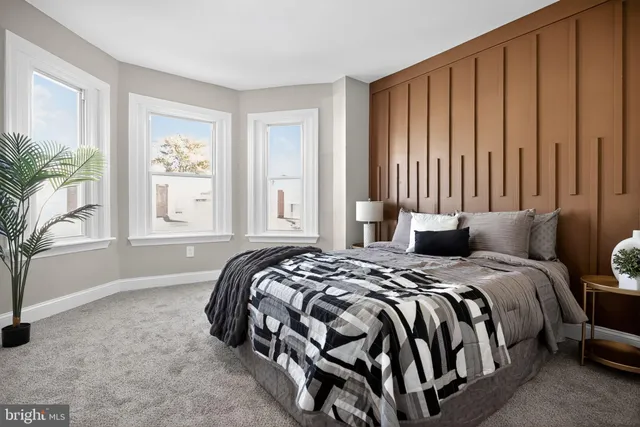 a bedroom with a large bed and a window