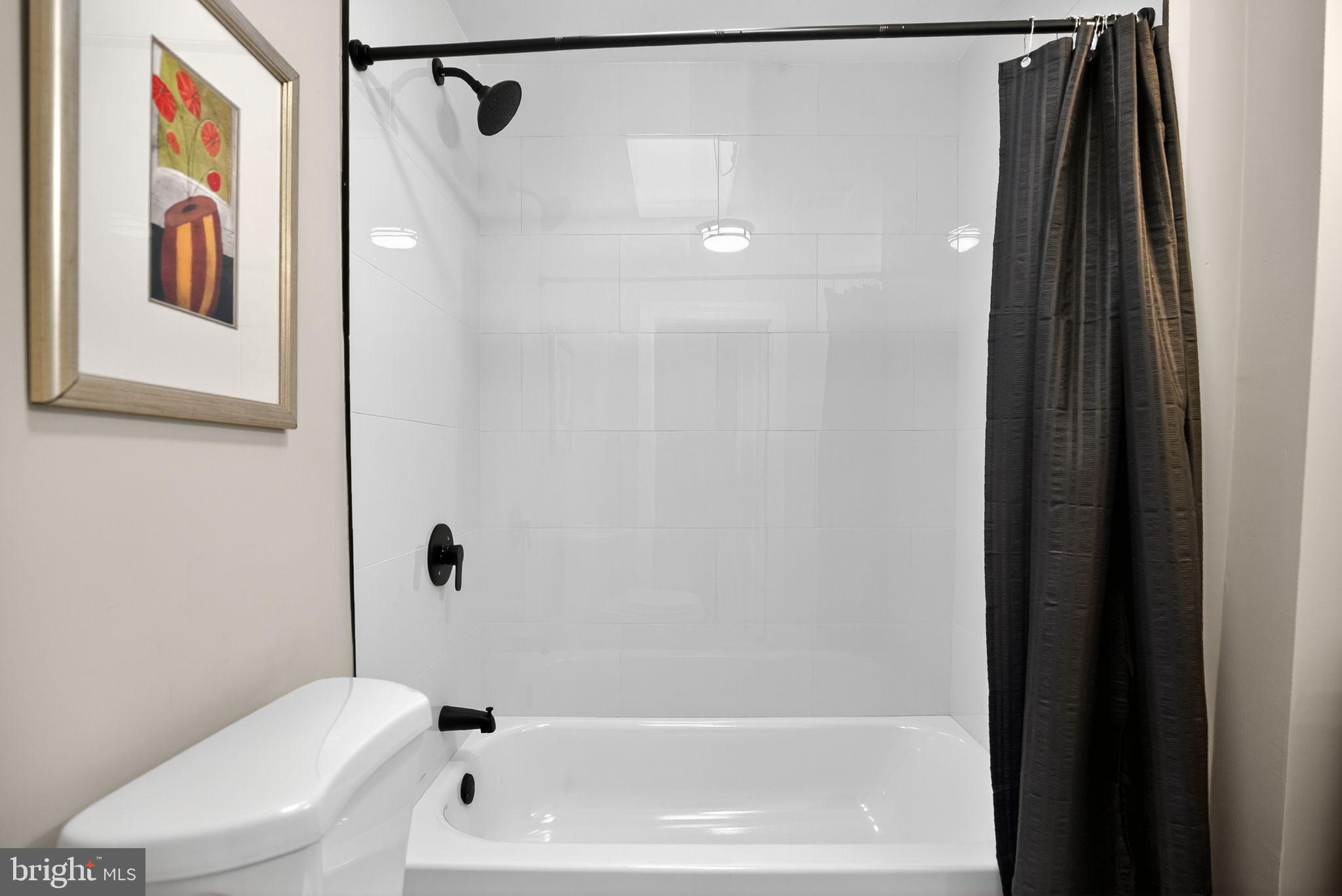 258 West Sheldon Street Philadelphia, PA 19120 - Photo 19 of 29 a bathroom with a bathtub and a shower