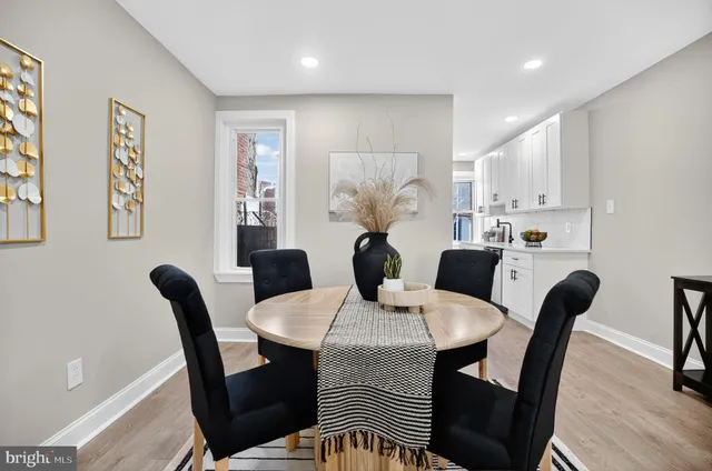 a dining room with furniture and wooden floor