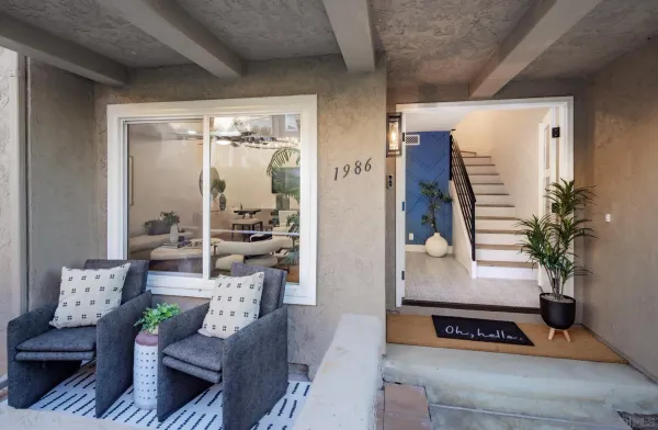 a living room with furniture and a potted plant