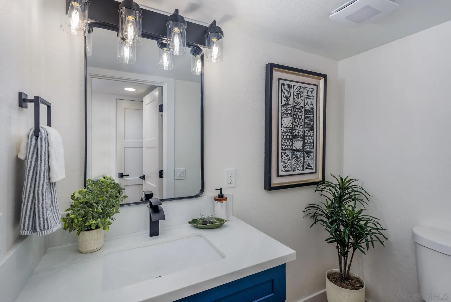 1986 Azure Way Encinitas, CA 92024 - Photo 15 of 20 a bathroom with a sink a mirror and a potted plant