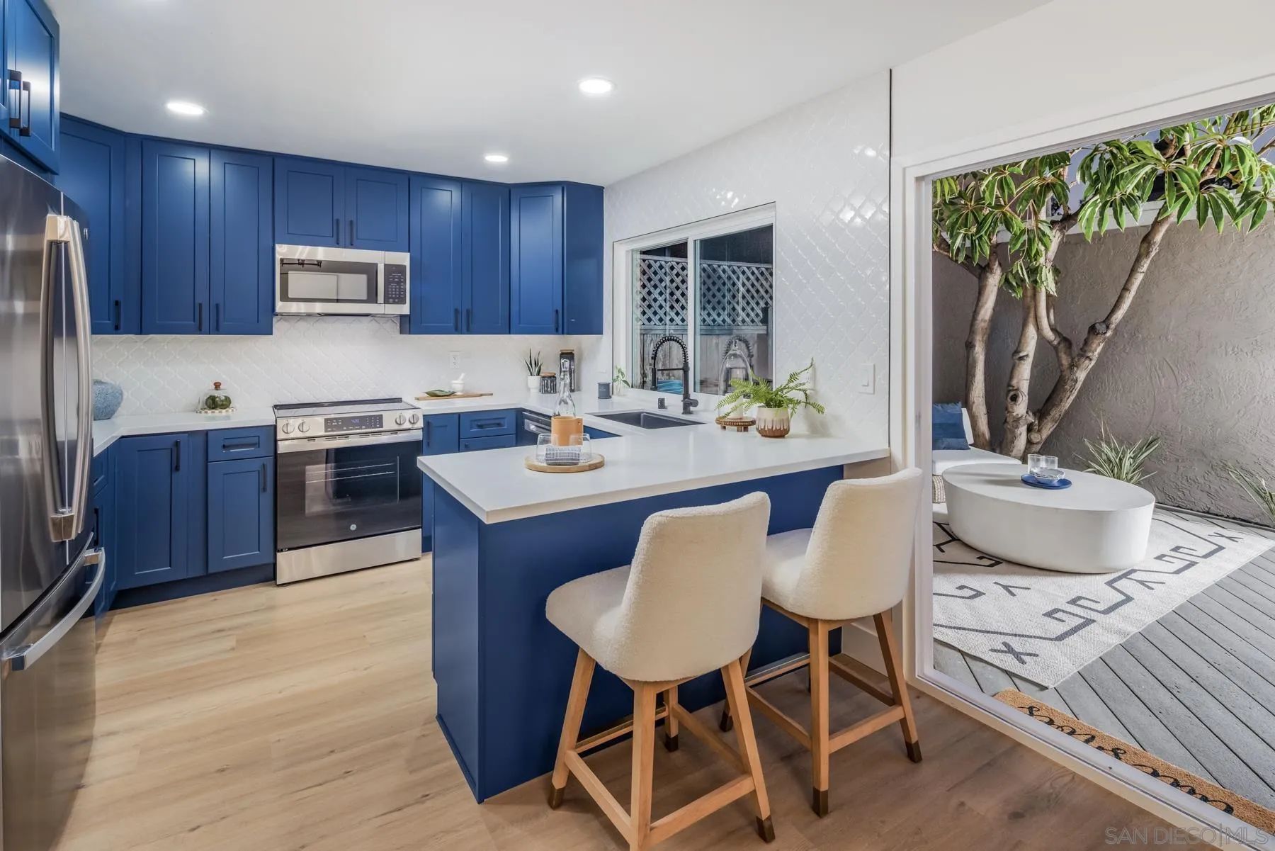 1986 Azure Way Encinitas, CA 92024 - Photo 9 of 20 a kitchen with granite countertop a sink stove and refrigerator