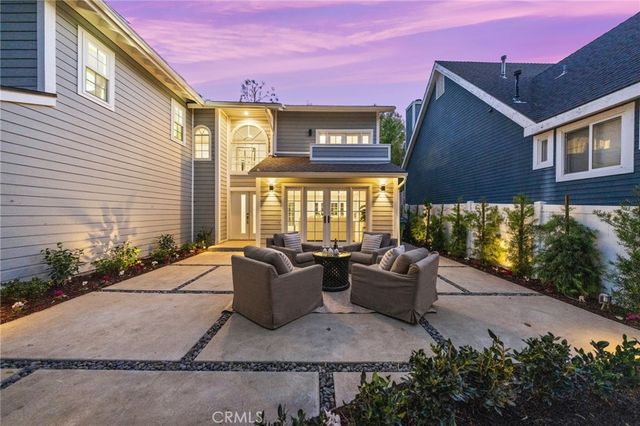 a front view of a house with lots of green space