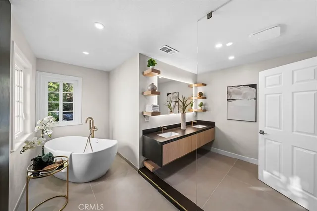 a spacious bedroom with a bed and a couch