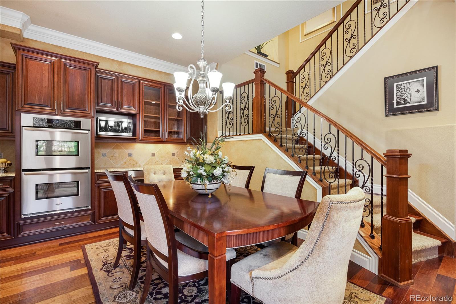 9132 Mornington Way Lone Tree, CO 80124 - Photo 12 of 44 a view of a dining room with furniture and chandelier