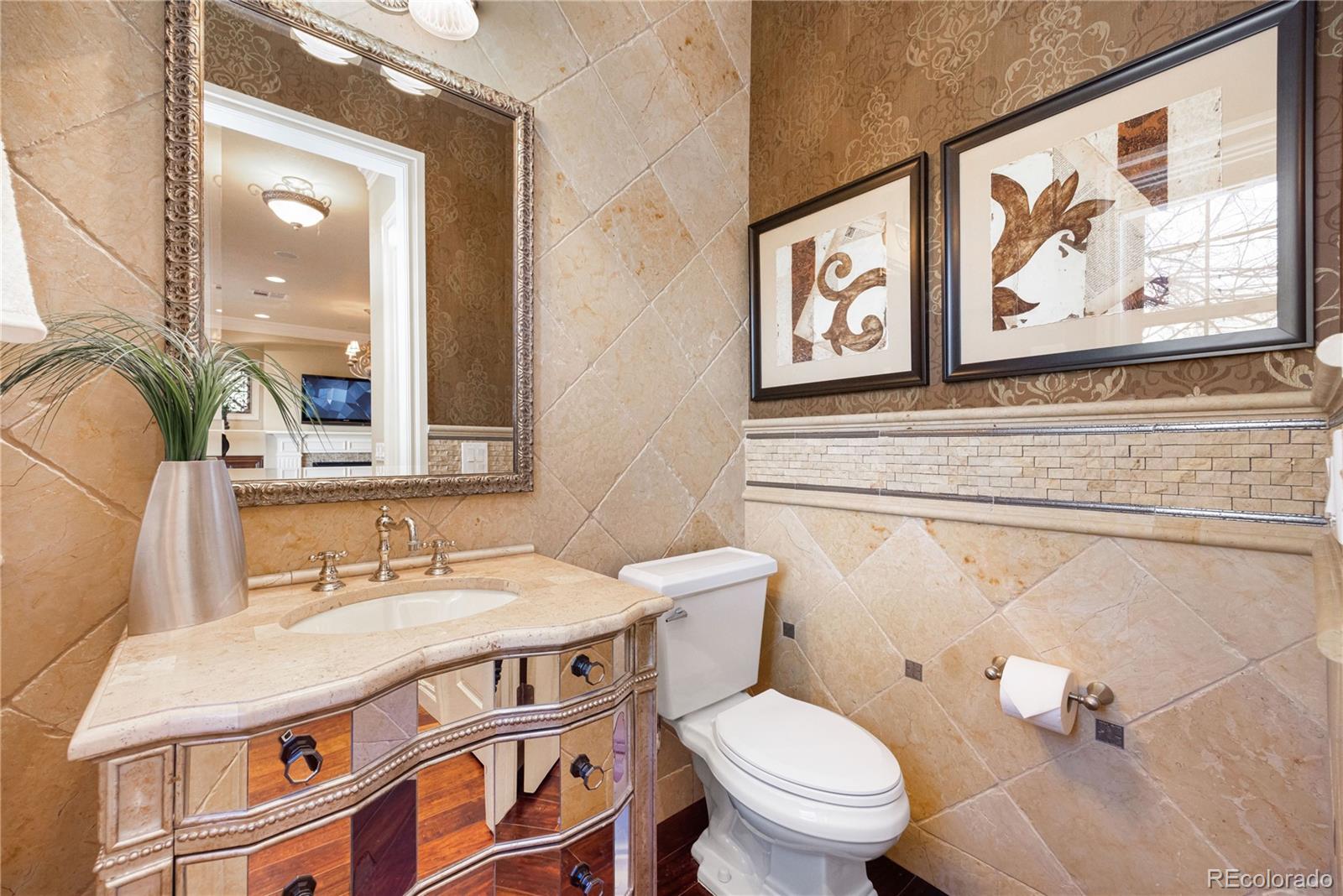 9132 Mornington Way Lone Tree, CO 80124 - Photo 16 of 44 a bathroom with a sink a toilet and a mirror