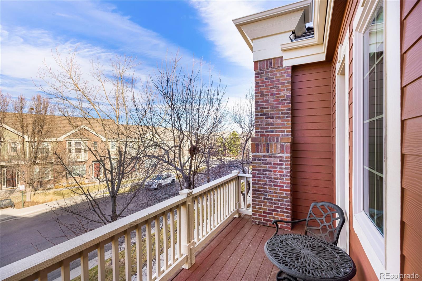 9132 Mornington Way Lone Tree, CO 80124 - Photo 23 of 44 a balcony with wooden floor and chair