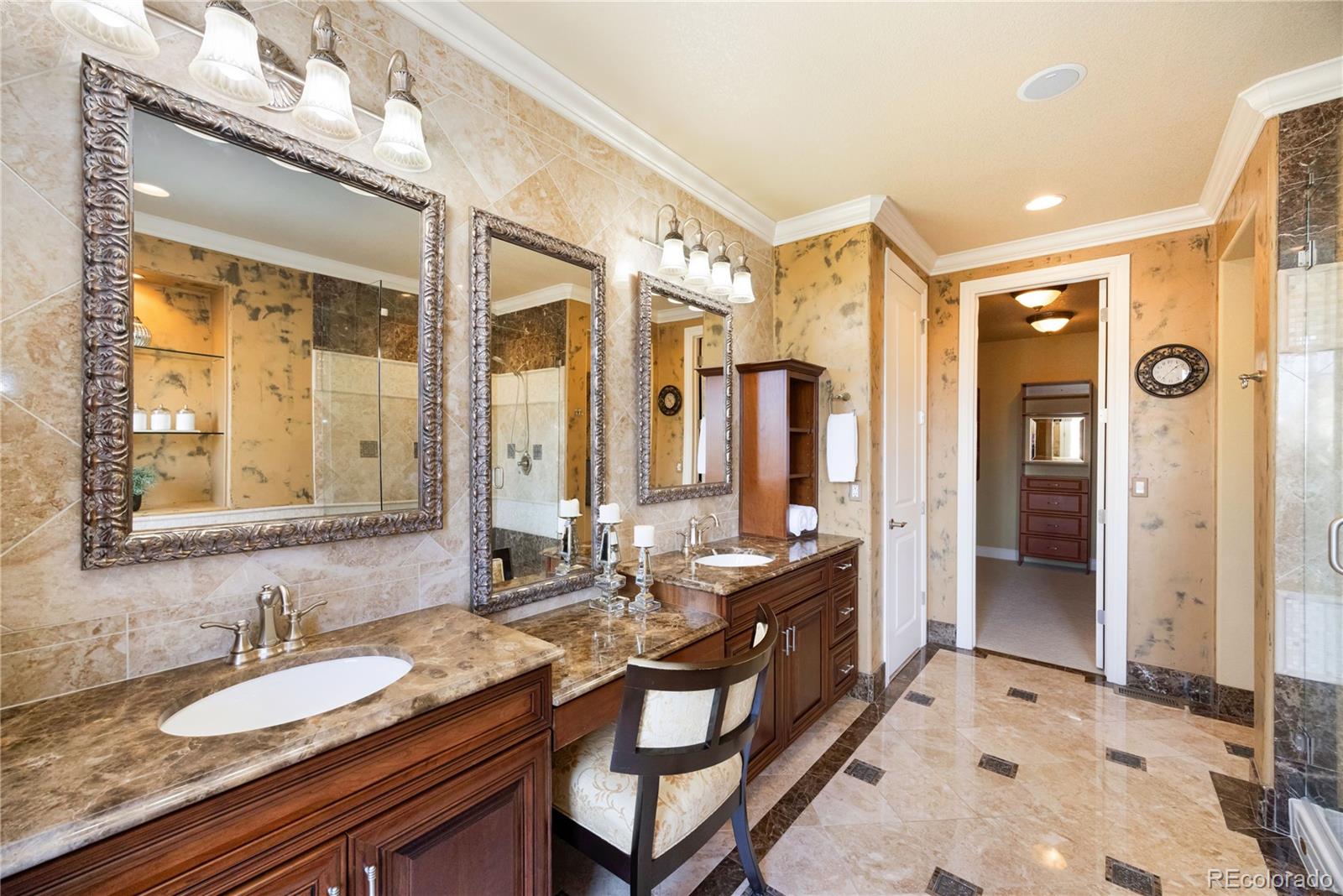 9132 Mornington Way Lone Tree, CO 80124 - Photo 25 of 44 a spacious bathroom with a granite countertop double vanity sink a mirror and a shower