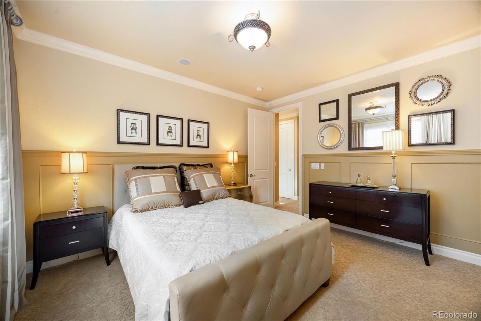 9132 Mornington Way Lone Tree, CO 80124 - Photo 29 of 44 a bedroom with a bed and a dresser