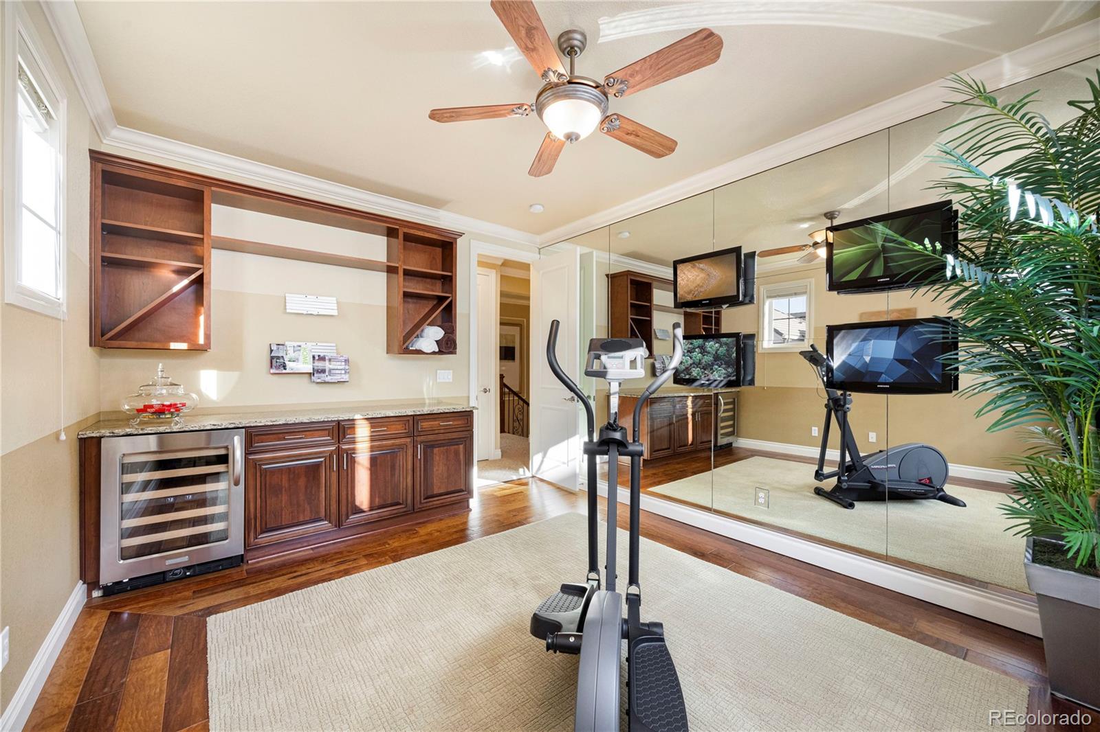 9132 Mornington Way Lone Tree, CO 80124 - Photo 32 of 44 a living room with furniture and a flat screen tv