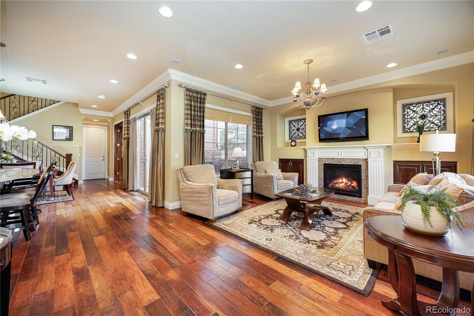9132 Mornington Way Lone Tree, CO 80124 - Photo 5 of 44 a living room with furniture a flat screen tv and a fireplace