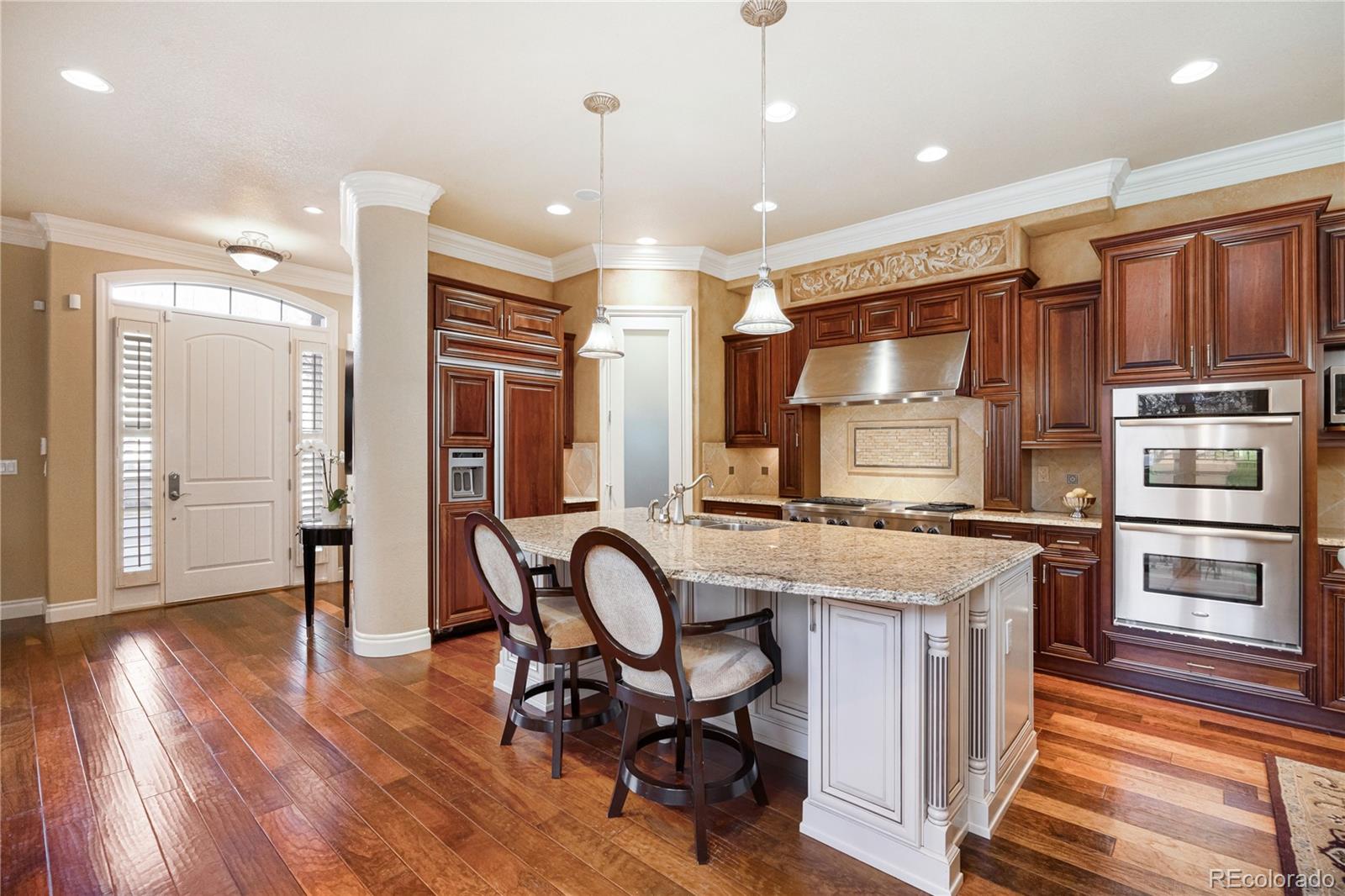 9132 Mornington Way Lone Tree, CO 80124 - Photo 8 of 44 a kitchen with stainless steel appliances granite countertop a stove refrigerator and cabinets