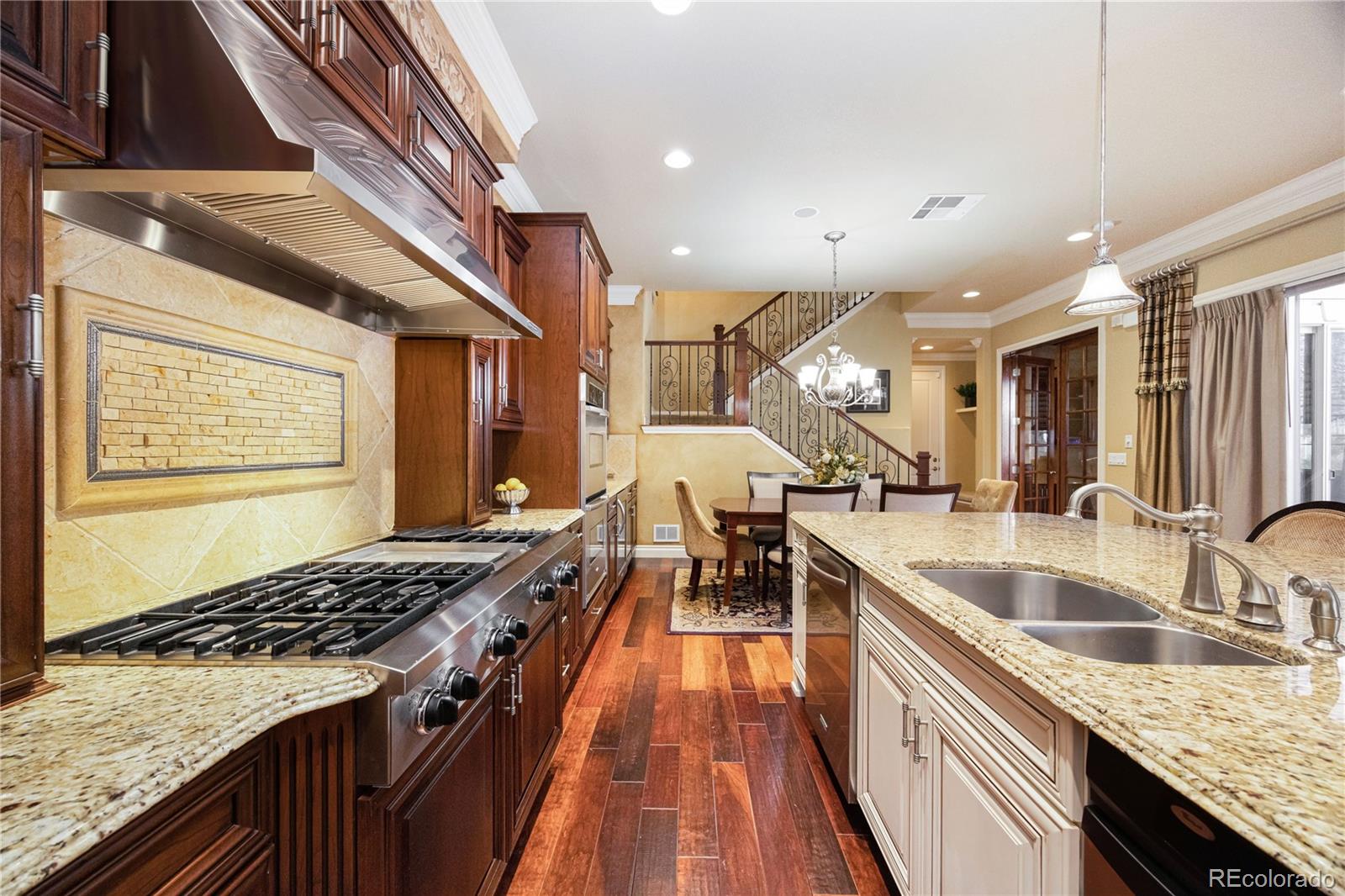9132 Mornington Way Lone Tree, CO 80124 - Photo 10 of 44 a kitchen with granite countertop a sink stove and cabinets