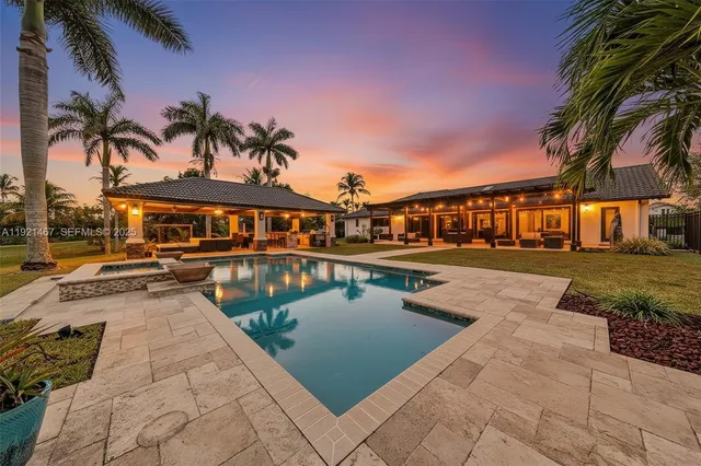 a view of swimming pool with outdoor seating and a pathway