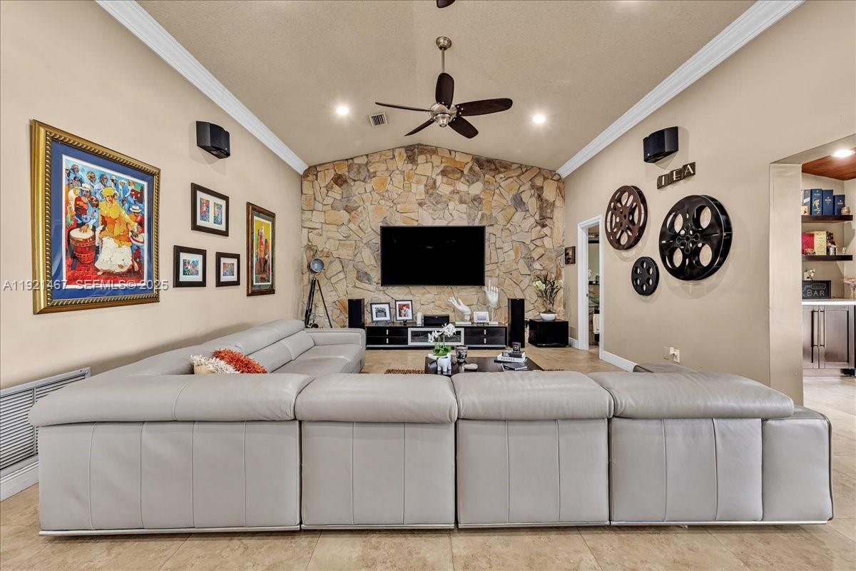 3801 Southwest 141st Avenue Miramar, FL 33027 - Photo 31 of 99 a living room with furniture a flat screen tv and a wall clock