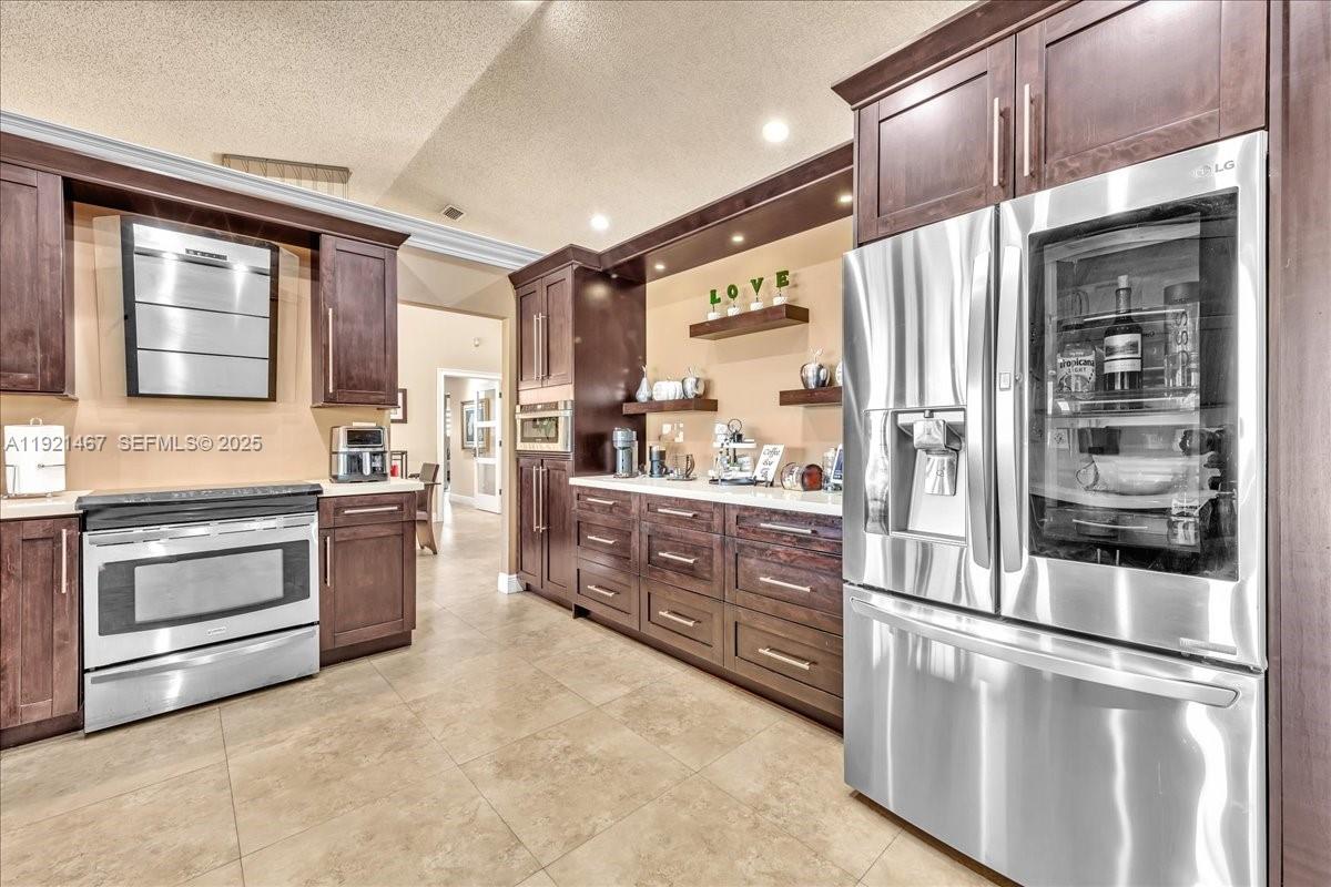 3801 Southwest 141st Avenue Miramar, FL 33027 - Photo 39 of 99 a kitchen with stainless steel appliances and cabinets