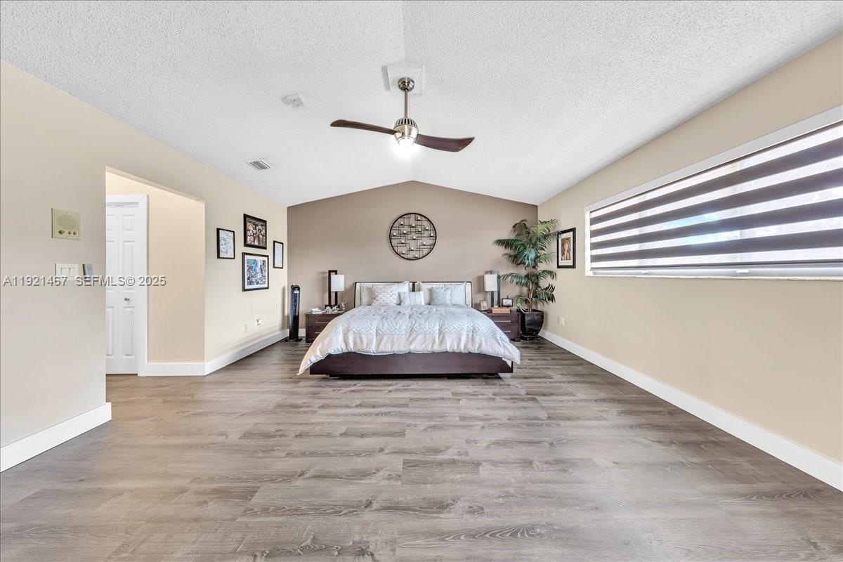 3801 Southwest 141st Avenue Miramar, FL 33027 - Photo 48 of 99 a view of a livingroom with a dinning area hardwood floor and a ceiling fan