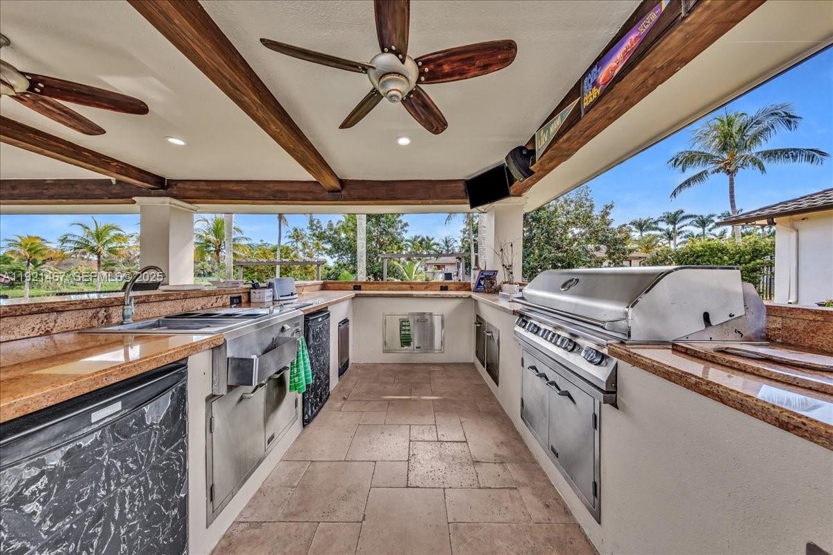 3801 Southwest 141st Avenue Miramar, FL 33027 - Photo 74 of 99 a kitchen with stainless steel appliances granite countertop a sink and stove