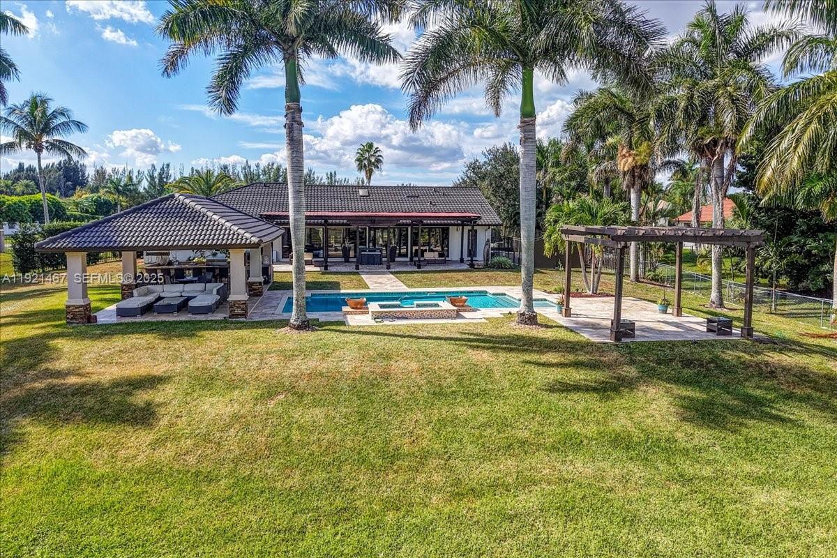 3801 Southwest 141st Avenue Miramar, FL 33027 - Photo 92 of 99 a view of a house with swimming pool and sitting area