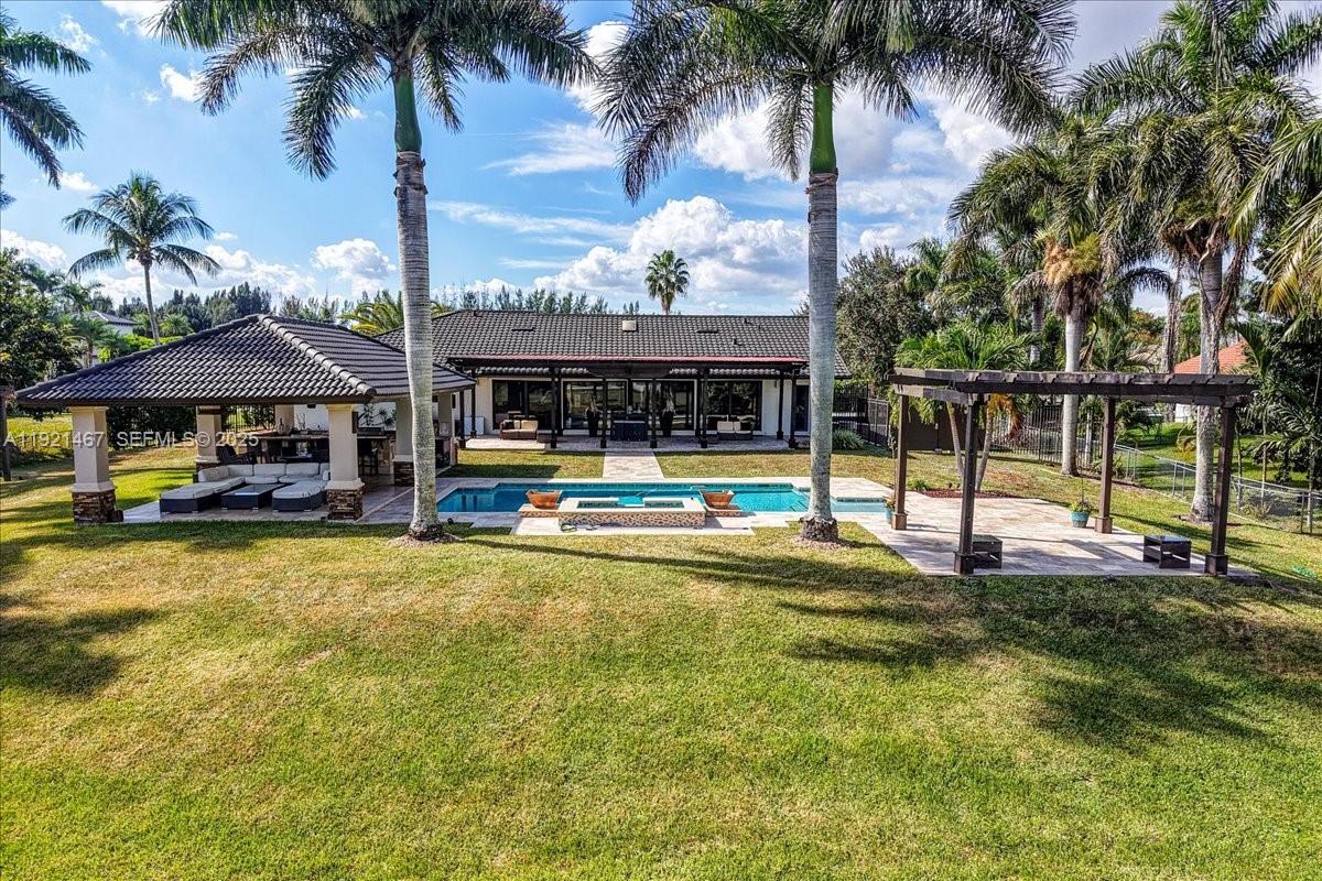 3801 Southwest 141st Avenue Miramar, FL 33027 - Photo 93 of 99 a view of a house with swimming pool and sitting area