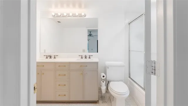 a bathroom with a sink toilet and a mirror