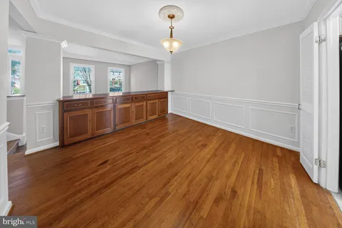 a living room with hard wood floors and a ceiling fan